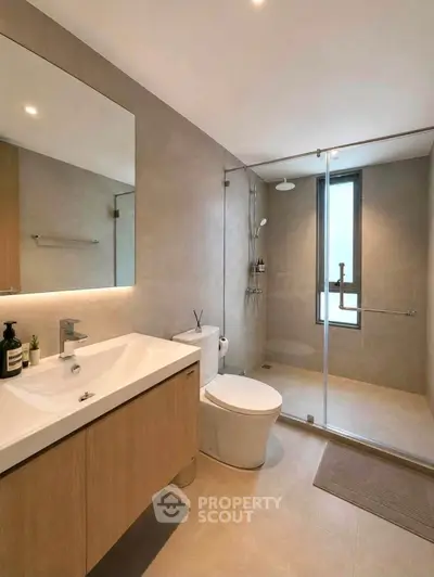 Modern bathroom with sleek fixtures and glass shower enclosure