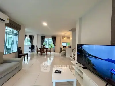 Spacious modern living room with open layout and large windows for natural light.