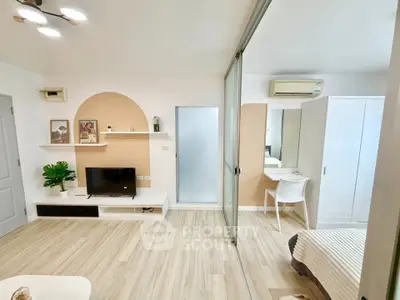 Modern studio apartment with stylish decor and sliding glass partition