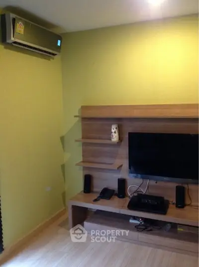 Modern living room with air conditioning and entertainment center