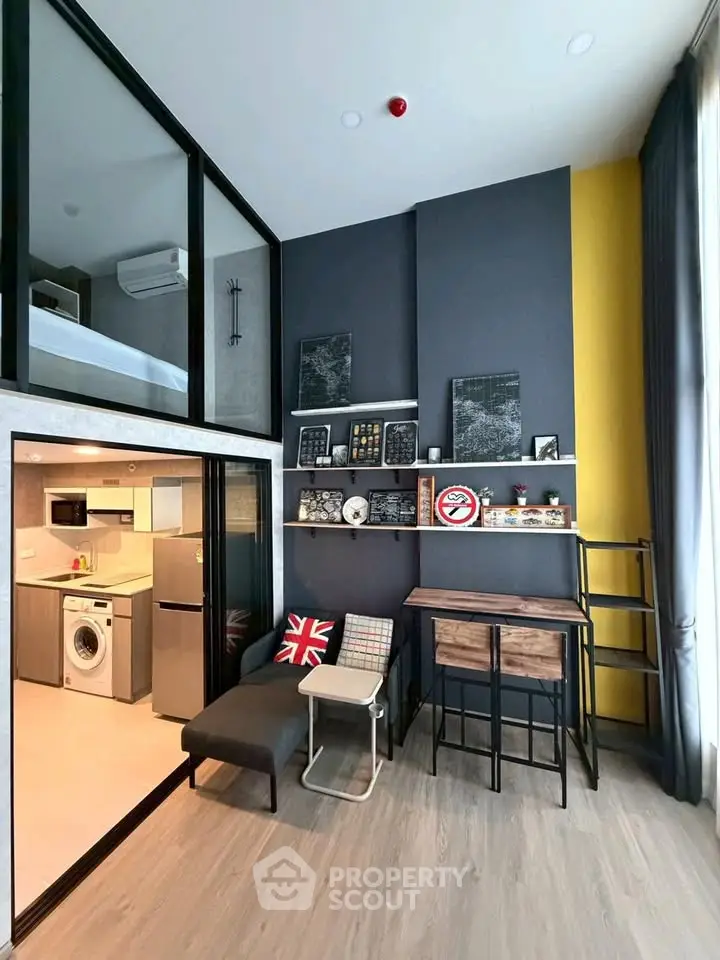 Modern loft apartment with stylish decor and mezzanine bedroom, featuring open kitchen and cozy living area.