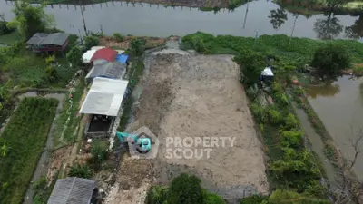 Aerial view of a rural property with a large cleared land area by a river, ideal for development.