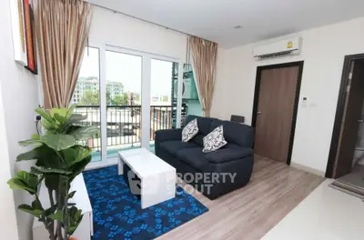 Modern living room with balcony access and stylish decor