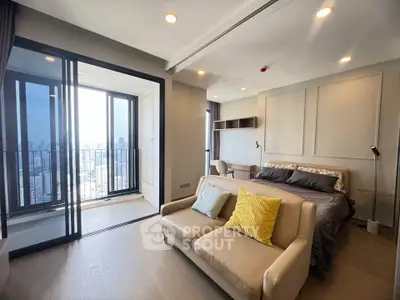 Modern studio apartment with balcony and city view, featuring cozy living area and stylish bedroom.