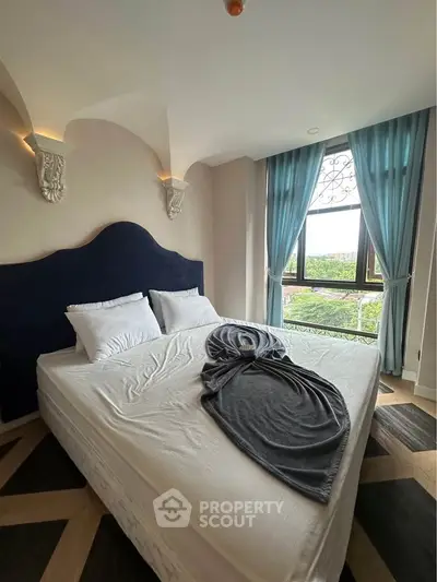 Luxurious bedroom with elegant decor and large window offering scenic views