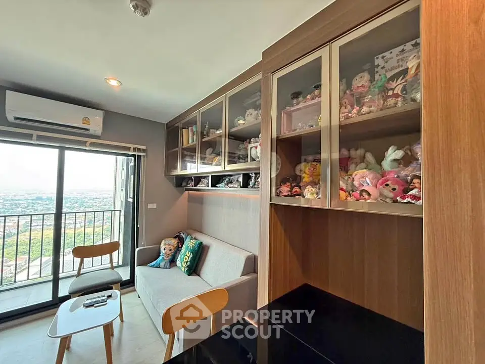 Charming living room with balcony view and stylish display cabinets in modern apartment.