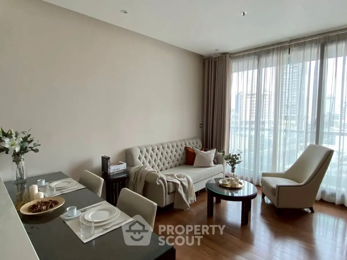 Elegant living room with modern decor and large windows offering city views.