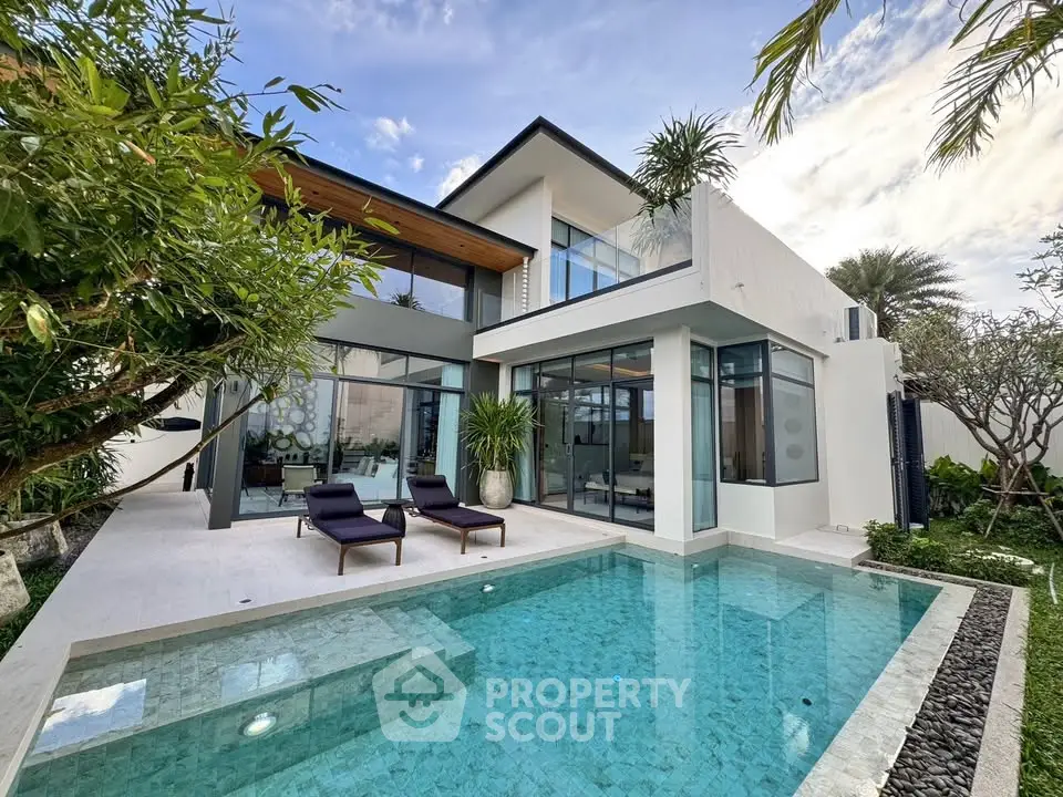 Luxurious modern villa with private pool and lush garden, featuring sleek architecture and large glass windows.