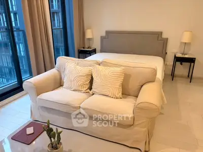Chic bedroom with cozy sofa and modern decor in urban apartment