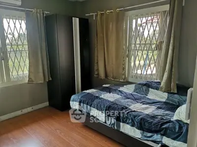 Cozy bedroom with large windows and modern decor