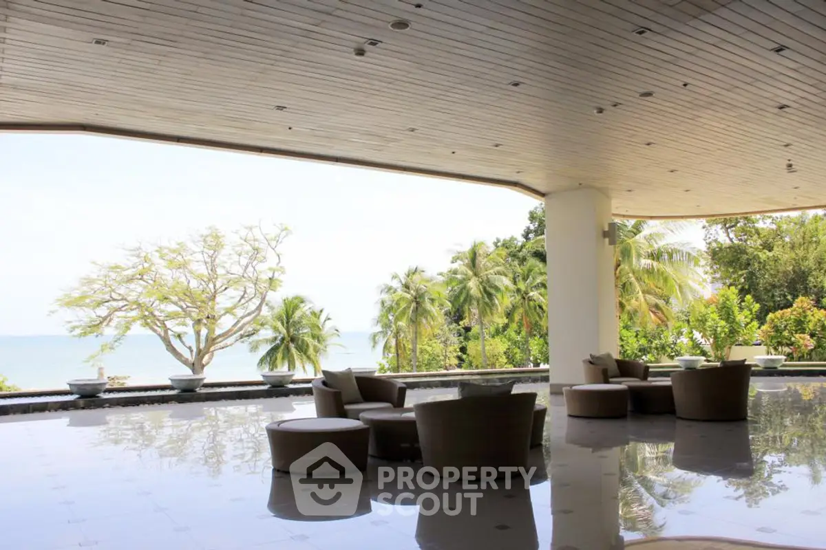 Luxurious open-air lounge with stunning ocean view and tropical surroundings