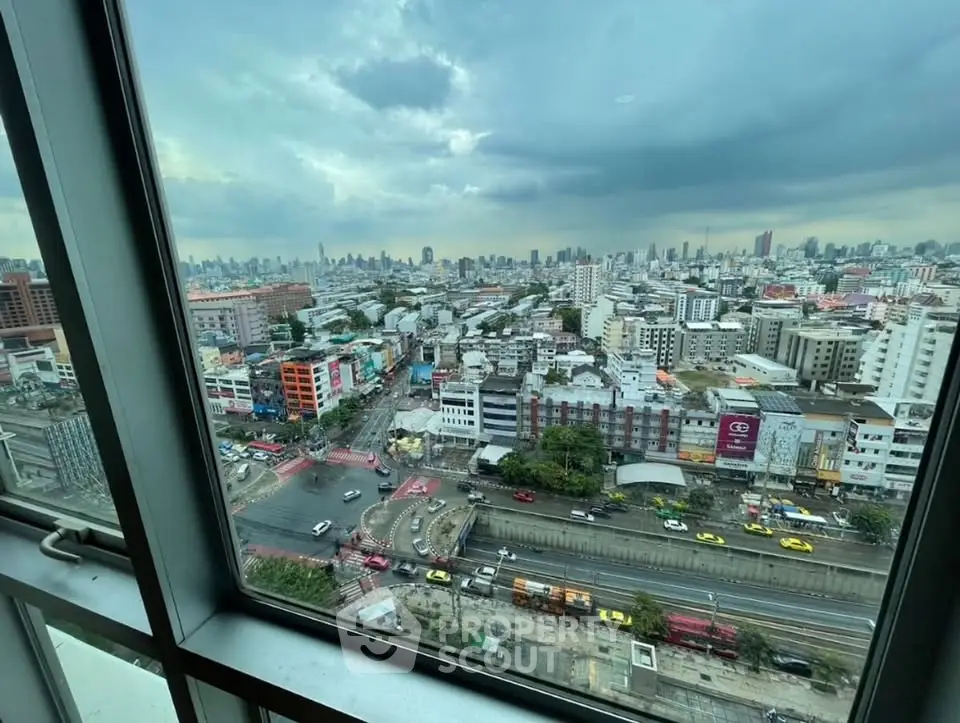 Stunning cityscape view from high-rise building window, showcasing vibrant urban life and skyline.