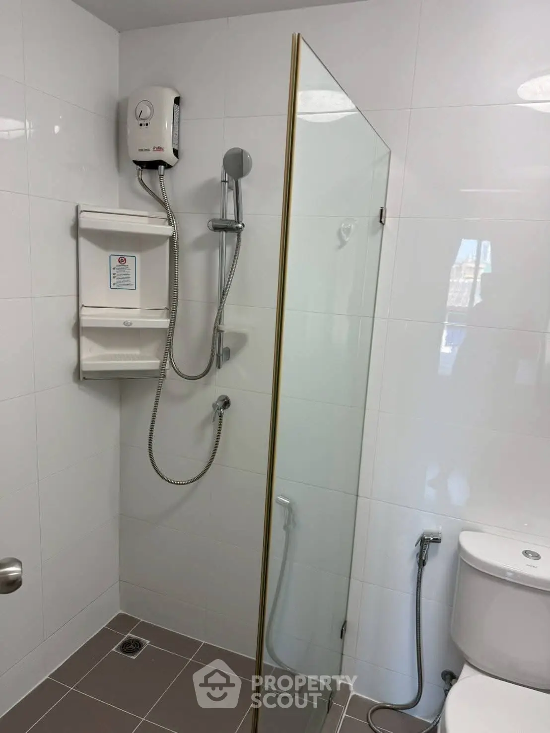 Modern bathroom with glass shower partition and sleek fixtures