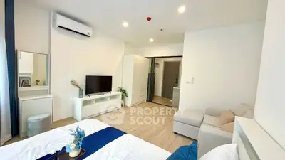 Modern bedroom with minimalist decor, featuring a cozy bed, TV, and ample storage space.