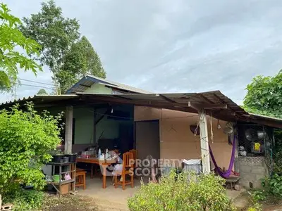 Charming rustic house with outdoor dining area and lush greenery
