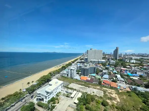 Stunning beachfront cityscape with high-rise buildings and ocean view, perfect for luxury real estate investment.