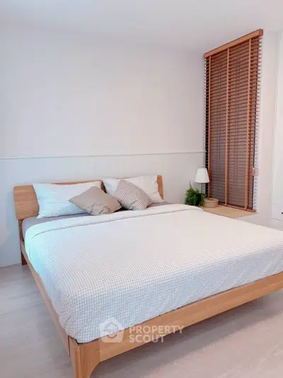 Modern bedroom with wooden bed frame and stylish decor