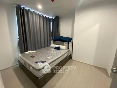 Modern bedroom with cozy bed and stylish curtains in a contemporary apartment.