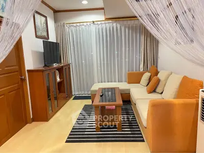 Cozy living room with modern furniture and natural light, perfect for relaxation and entertainment.