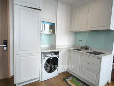 Modern kitchen with integrated washing machine and sleek cabinetry