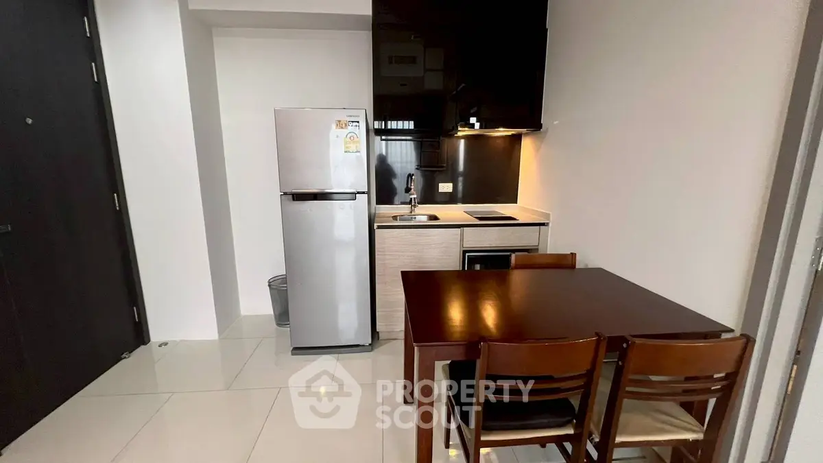 Modern compact kitchen with dining area and sleek appliances