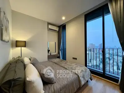 Modern bedroom with city view and balcony access in high-rise apartment.
