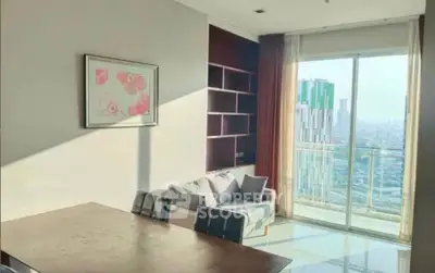 Bright living room with modern decor and city view from large window.