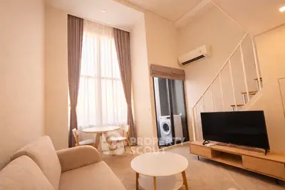 Modern living room with high ceiling and washing machine in cozy apartment