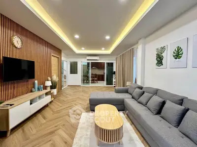 Stylish modern living room with gray sectional sofa and wooden accents