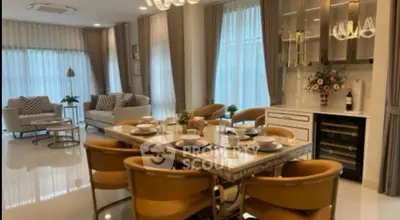 Luxurious open-plan living and dining area with elegant decor and ample natural light.