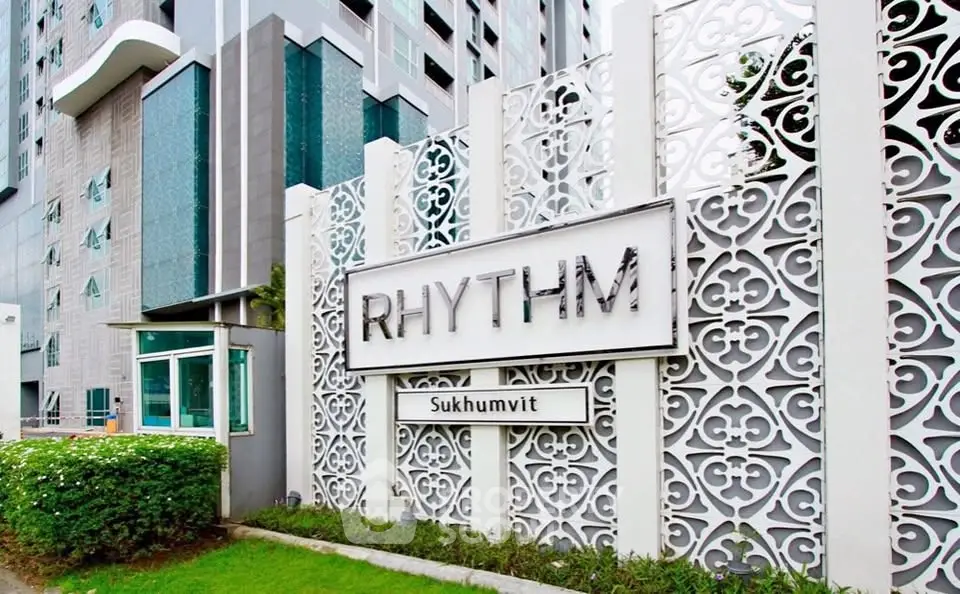 Modern condominium exterior with stylish facade and lush greenery at Rhythm Sukhumvit.