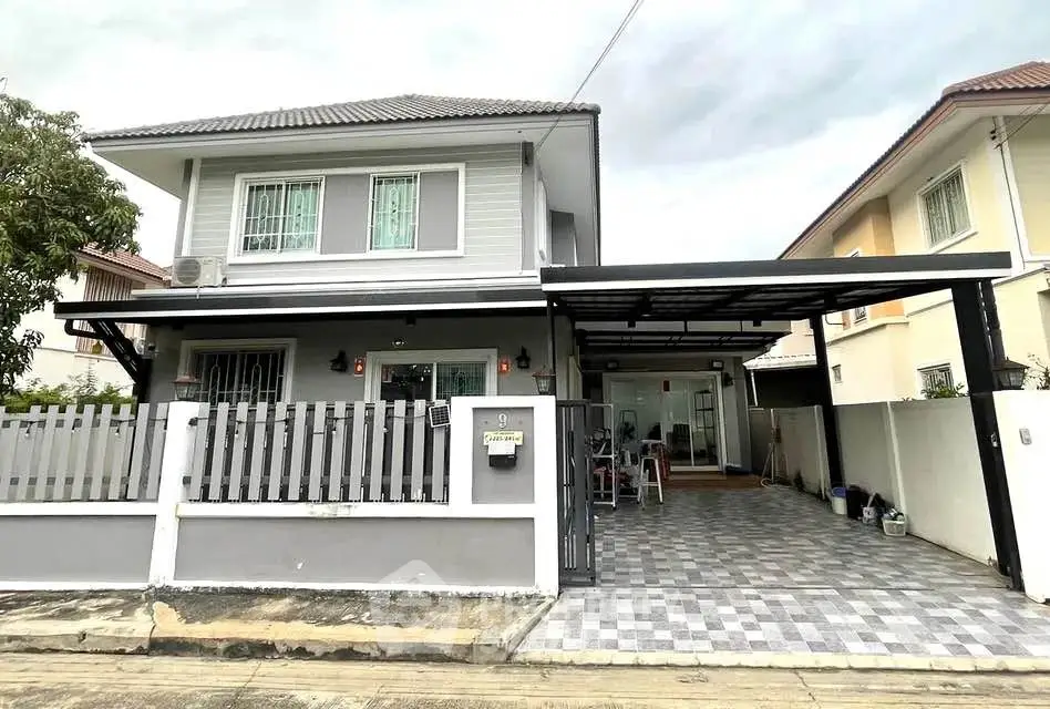 Charming two-story house with modern exterior and spacious driveway in a serene neighborhood.