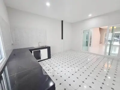 Spacious modern kitchen with sleek black countertops and open layout design