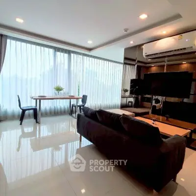 Spacious modern living room with large windows and sleek furnishings