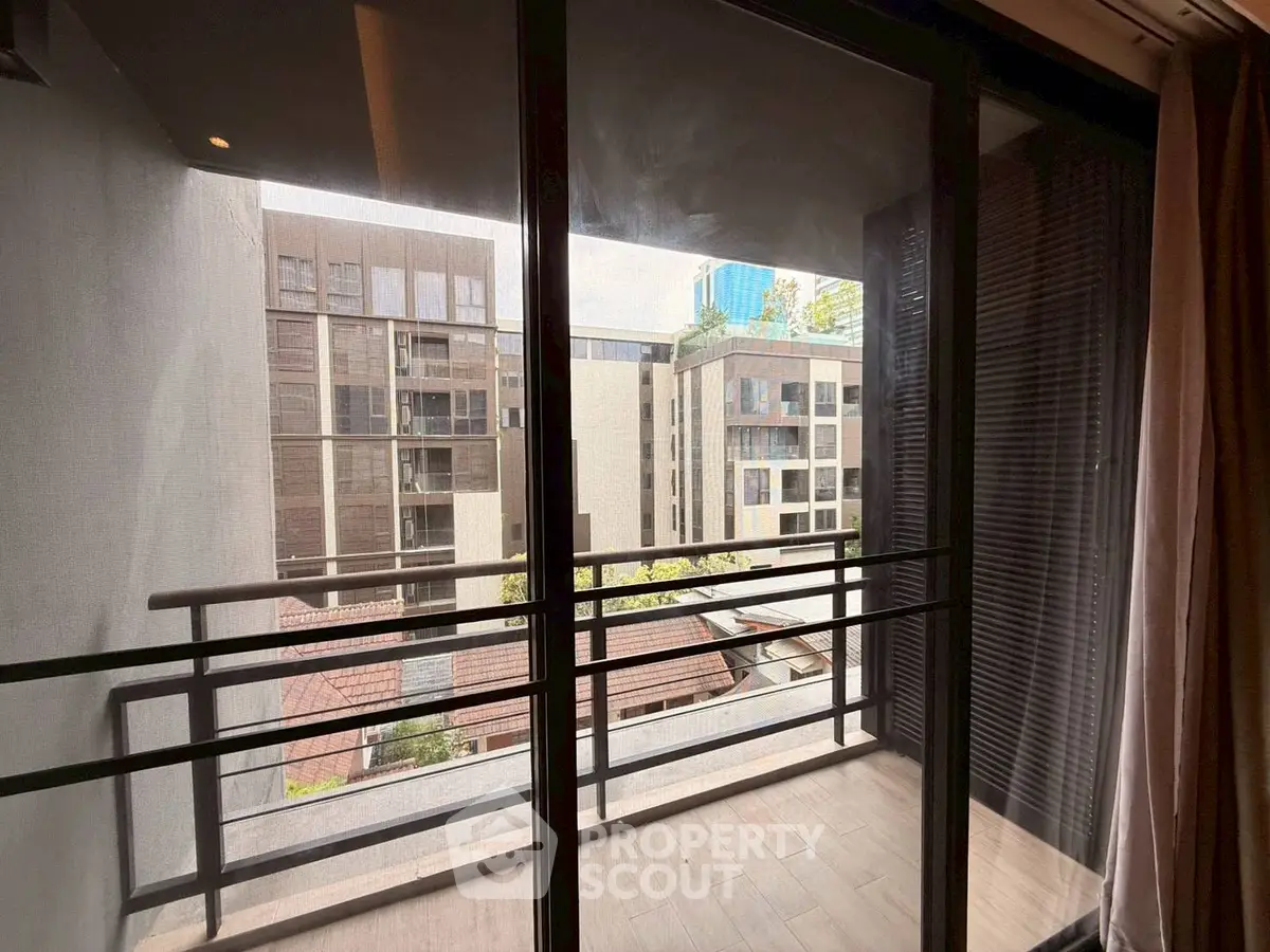 Modern apartment balcony with city view and sleek railing design