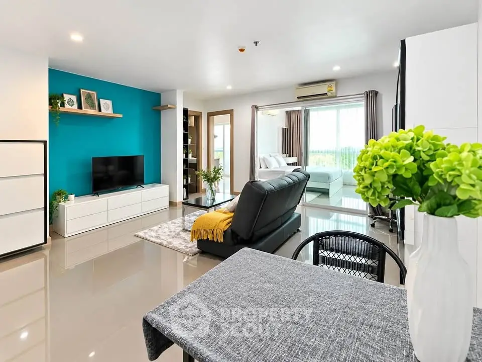 Spacious modern living room with vibrant accent wall and sleek furnishings