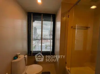 Modern bathroom with city view and glass shower enclosure