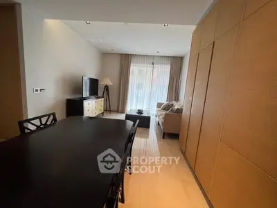 Spacious modern living room with elegant furniture and large windows for natural light.