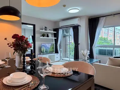 Modern living room with elegant dining setup and large windows offering a scenic view.