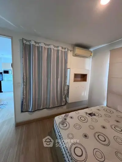 Cozy bedroom with modern decor and natural light, featuring a comfortable bed and stylish curtains.