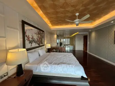 Luxurious bedroom with elegant decor and ambient lighting, featuring a large bed and stylish ceiling design.