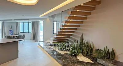 Luxurious open-plan living room with modern staircase and indoor garden