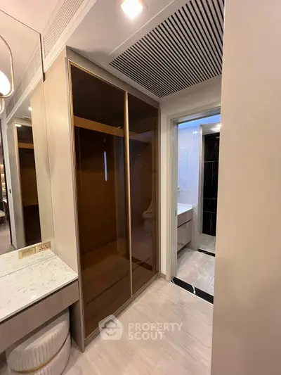 Modern bathroom with sleek design and elegant fixtures, featuring a spacious shower and stylish vanity.