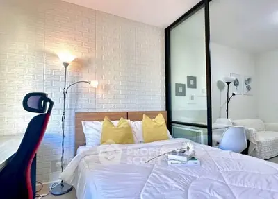 Modern bedroom with stylish decor, featuring a cozy bed, study desk, and elegant lighting.