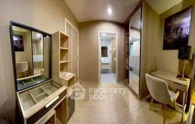 Modern bedroom with stylish furniture and ensuite bathroom, featuring a sleek design and ample storage space.