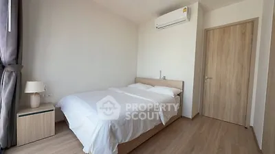 Modern minimalist bedroom with wooden flooring and air conditioning