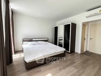 Spacious modern bedroom with minimalist design and ample natural light