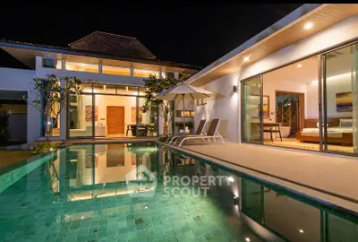 Luxurious modern villa with poolside view and elegant lighting at night.