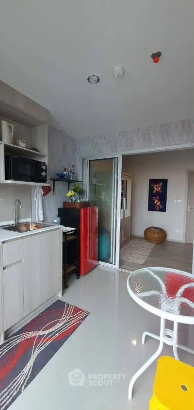 Modern kitchen with red fridge and open layout in stylish apartment