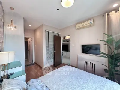 Modern bedroom with stylish decor, air conditioning, and natural light, perfect for comfort and relaxation.